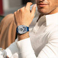 Close-up of a model wearing the TSAR BOMBA Reactor TB8213 staless steel Automatic Interchangeable Men's Watch. Features a sliver stainless steel case and bezel, powered by a Japanese automatic movement. Top dial: minutes; central dial: seconds. Bottom main display: hour hand = pointer reading + central window reading. The TB8213 utilizes the TSAR BOMBA interchangeable module system, allowing for quick and tool-free changes of the strap, bezel, and crown.blue strap