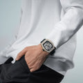 Close-up of a model wearing the TSAR BOMBA Elemental TB8208D men’s Black tonneau watch with a gold-tone stainless steel case and cubic zirconia bezel and skeleton dial.