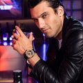 Close-up of a model wearing the TSAR BOMBA Reactor TB8213 staless steel Automatic Interchangeable Men's Watch. Features a gold stainless steel case and bezel, powered by a Japanese automatic movement. Top dial: minutes; central dial: seconds. Bottom main display: hour hand = pointer reading + central window reading. The TB8213 utilizes the TSAR BOMBA interchangeable module system, allowing for quick and tool-free changes of the strap, bezel, and crown.