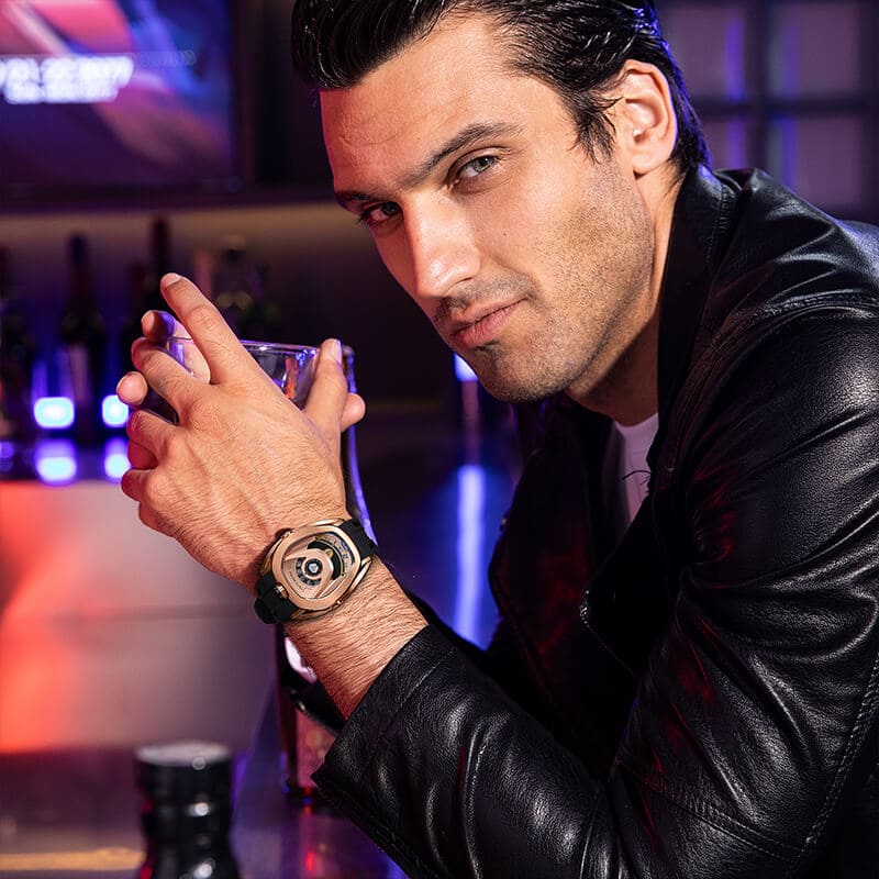 Close-up of a model wearing the TSAR BOMBA Reactor TB8213 staless steel Automatic Interchangeable Men's Watch. Features a gold stainless steel case and bezel, powered by a Japanese automatic movement. Top dial: minutes; central dial: seconds. Bottom main display: hour hand = pointer reading + central window reading. The TB8213 utilizes the TSAR BOMBA interchangeable module system, allowing for quick and tool-free changes of the strap, bezel, and crown.