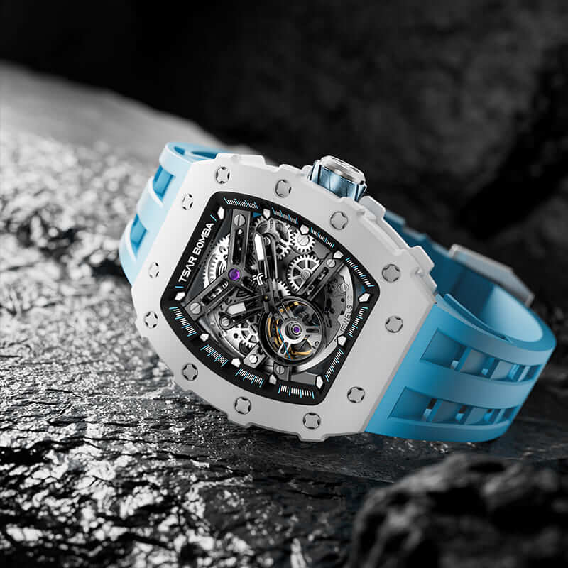 TSAR BOMBA Elemental TB8208C men’s Blue tonneau watch with a stainless steel case and white ceramic bezel and skeleton dial and blue strap.