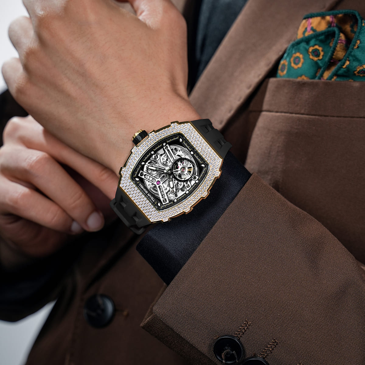 Close-up of a model wearing the TSAR BOMBA Elemental TB8208D men’s Black tonneau watch with a gold-tone stainless steel case and cubic zirconia bezel and skeleton dial.