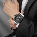 Close-up of a model wearing the TB8210CF Passion Red men’s tonneau watch, featuring a tonneau stainless steel case, a carbon fiber bezel, and white strap. The Seiko Epson automatic movement is displayed with a tourbillon at 9 o’clock, a power reserve indicator at 12 o’clock, and a 24-hour display at 6 o’clock.