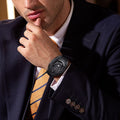 Close-up of a model wearing the TSAR BOMBA Reactor TB8213 Carbon Fiber Automatic Interchangeable Men's Watch. Features a black stainless steel case and carbon fiber bezel, powered by a Japanese automatic movement. Top dial: minutes; central dial: seconds. Bottom main display: hour hand = pointer reading + central window reading. The TB8213 utilizes the TSAR BOMBA interchangeable module system, allowing for quick and tool-free changes of the strap, bezel, and crown.