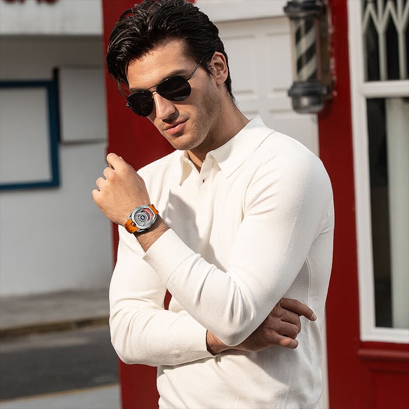 Close-up of a model wearing the TSAR BOMBA Reactor TB8213 staless steel Automatic Interchangeable Men's Watch. Features a sliver stainless steel case and bezel, powered by a Japanese automatic movement. Top dial: minutes; central dial: seconds. Bottom main display: hour hand = pointer reading + central window reading. The TB8213 utilizes the TSAR BOMBA interchangeable module system, allowing for quick and tool-free changes of the strap, bezel, and crown.orange strap