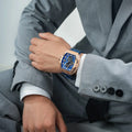  TSAR BOMBA Elemental TB8211Q Stainless Steel Tonneau Chronograph Watch. Features a stainless steel case and a precision-machined quartz movement. The textured dial integrates date display and chronograph function. A 1/20th-second counter is located at 12 o'clock, the date display at 3 o'clock, the hour/minute counter at 6 o'clock, and the seconds counter at 9 o'clock.--Model wearing display