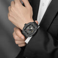 Close-up of a model wearing the TSAR BOMBA Elemental TB8210CF Cool Black men’s tonneau watch, featuring a tonneau stainless steel case, a carbon fiber bezel, and black strap. The Seiko Epson automatic movement is displayed with a tourbillon at 9 o’clock, a power reserve indicator at 12 o’clock, and a 24-hour display at 6 o’clock.