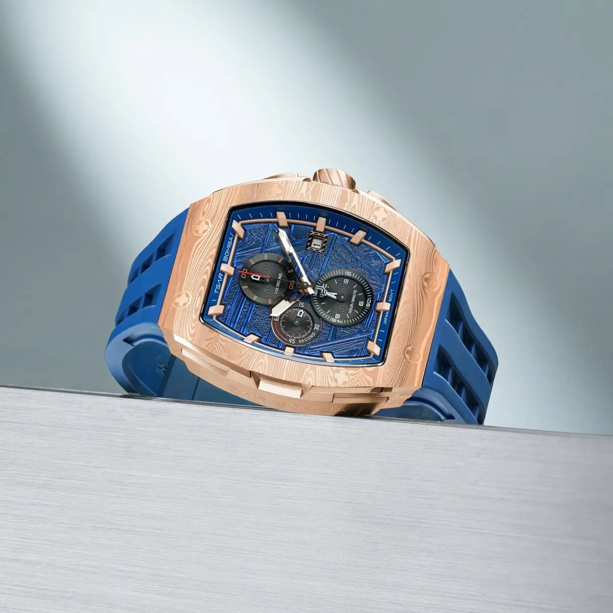  TSAR BOMBA Elemental TB8211Q Stainless Steel Tonneau Chronograph Watch. Features a stainless steel case and a precision-machined quartz movement. The textured dial integrates date display and chronograph function. A 1/20th-second counter is located at 12 o'clock, the date display at 3 o'clock, the hour/minute counter at 6 o'clock, and the seconds counter at 9 o'clock.--Scene display