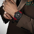 Close-up of a model wearing the TSAR BOMBA Elemental TB8210CF Passion Red men’s tonneau watch, featuring a tonneau stainless steel case, a carbon fiber bezel, and red strap. The Seiko Epson automatic movement is displayed with a tourbillon at 9 o’clock, a power reserve indicator at 12 o’clock, and a 24-hour display at 6 o’clock.